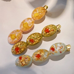 Set of three handmade resin hair clips with dried flowers and gold foil accents