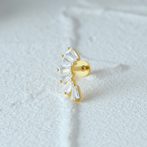 Macro shot of gold S925 silver ear stud featuring curved row of rectangular zircon stones