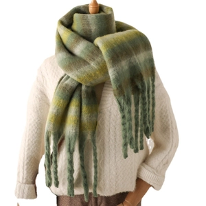 Green and yellow striped tassel scarf in soft cashmere-like knit on mannequin