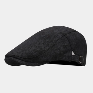 Detail of adjustable bronze buckle on dark grey linen flat cap for custom sizing