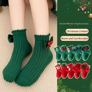 Kids Christmas cotton socks with festive red and green bows and reindeer decorations