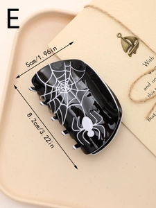 Detail view of Halloween spider web hair claw clip with dimensions on a beige tray