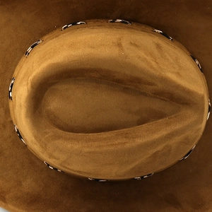 Detail of dark brown faux suede western cowboy hat with black and white woven band