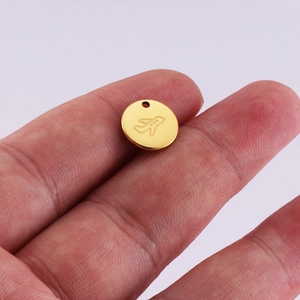 Polished 18K gold plated stainless steel round pendant with engraved airplane icon