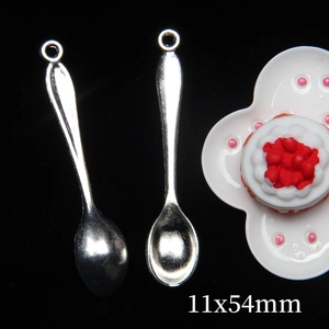 Macro shot of silver miniature alloy spoons measuring 11x54mm for dollhouse accessories