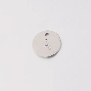 Macro shot of 12mm stainless steel pendant with engraved capital letter A and mirror finish