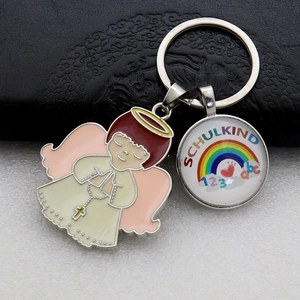 Metal rainbow keychain with enamel angel pendant and Schukind school glass charm