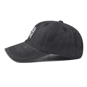 Detailed side view of washed vintage charcoal grey baseball cap with KING MM embroidery