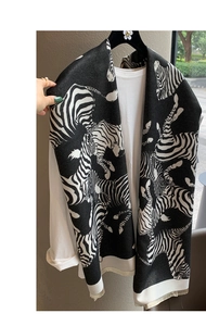 Close-up of zebra pattern scarf with soft fabric and decorative fringe details
