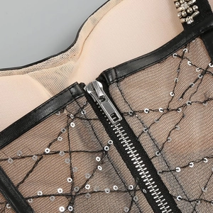 Detailed close-up of a sequined bodice showing silver zipper and mesh fabric texture
