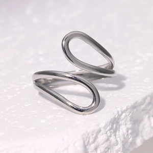 Macro shot of minimalist silver double-layer curved line open ring on stone surface