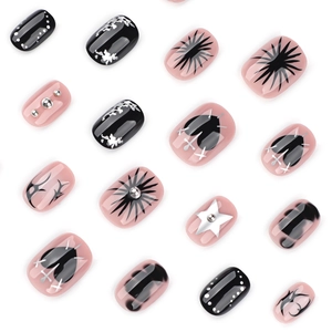 Gothic Y2K press-on nails featuring black hearts and pink star patterns on a white background