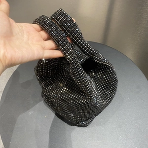 Elegant black rhinestone bucket handbag with knotted handle and sparkling crystals