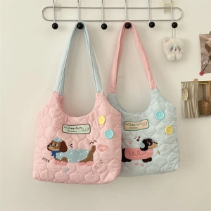 Close-up of quilted tote bag featuring cartoon puppy embroidery and colorful buttons
