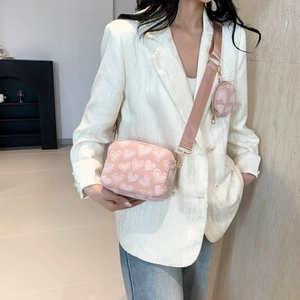 Pink heart print crossbody bag with wide strap and matching round coin purse detail