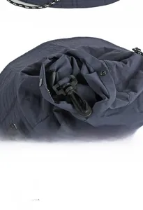 Detail of packable rain hat featuring quick-dry fabric, chin strap, and built-in storage bag