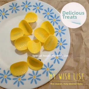 Detailed view of creative realistic potato chip hair clip on a floral porcelain plate