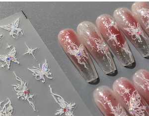 Detail of 5D embossed nail stickers featuring white butterflies and star motifs with rhinestones