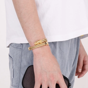 Mens punk gold dragon twisted wire steel cuff bracelet styled on a male wrist