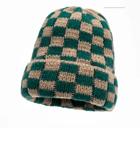 Detail of green and light brown checkerboard pattern knit beanie with folded cuff texture