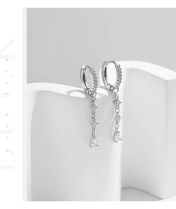Detail of S925 silver tassel earrings featuring sparkling pear-cut cubic zirconia drops