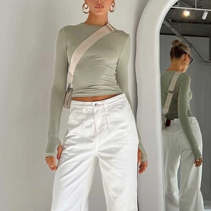 Detail of slim fit long sleeve top with thumb holes in sage green jersey fabric