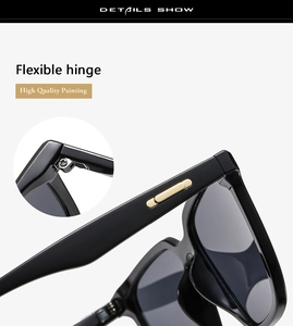 Detail of flexible hinges and gold metal trim on black glossy sunglasses frames