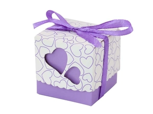 Detail of purple wedding candy box with heart cut-outs and elegant satin ribbon bow