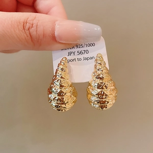 Detailed view of 925 silver gold-plated geometric earrings with unique textured finish