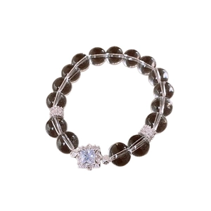 Elegant beaded bracelet with brown translucent crystals and a square zircon pendant