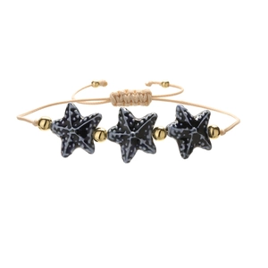 Adjustable beige woven bracelet featuring black starfish pendants and golden beads accents
