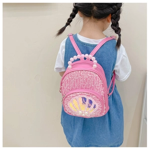 Pink sequin shell backpack for girls with pearl handle shown on child's back