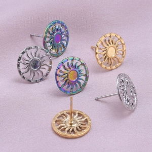 Macro detail of sunburst stud earrings in silver, gold, and rainbow stainless steel