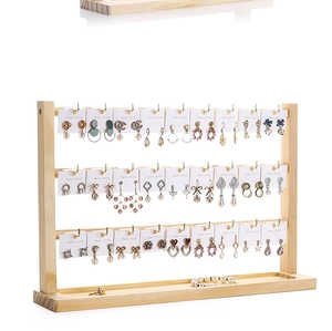 Three-tier solid wood earring display stand with a base storage tray for jewelry