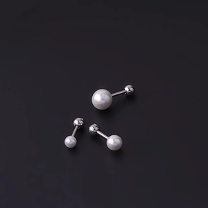 Three sizes of white pearl stud earrings with surgical steel posts on black background