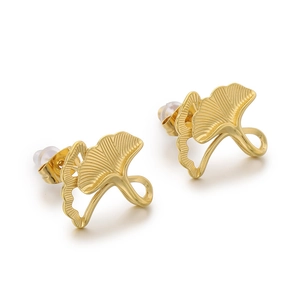Pair of golden ginkgo leaf stud earrings in stainless steel with brushed texture on white background