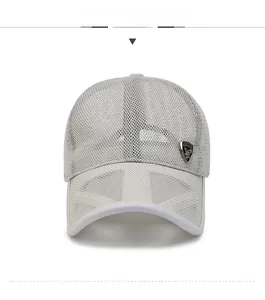 Detailed close-up of breathable light gray mesh fabric with a bronze shield metal badge