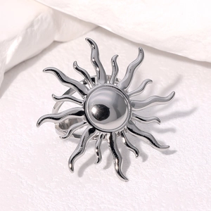 Polished stainless steel sunflower ring with sunburst design on a white background