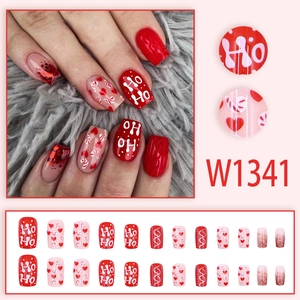 Christmas press-on nails set with red glitter, heart patterns, and festive Ho Ho design