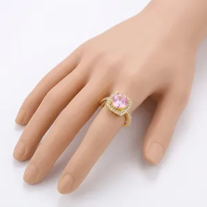 Adjustable brass ring with pink square zircon and white stones in gold finish