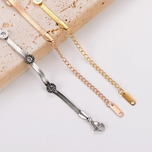 Detail of three-tone snake chains with Roman numeral discs and sparkling crystals