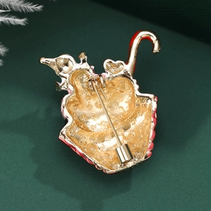 Exquisite gold heart brooch with red enamel and secure pin clasp on dark green background
