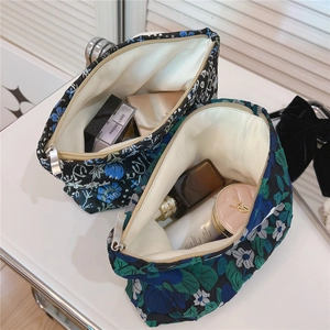 Macro detail of floral jacquard makeup bags showing large storage capacity and metal zipper