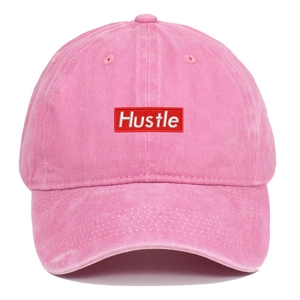 Close-up of Hustle rectangular embroidered patch on pink washed cotton baseball cap