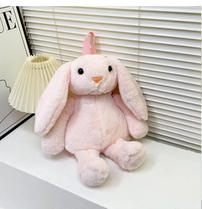 Detailed texture of pink plush rabbit backpack with soft long fur and cute facial details