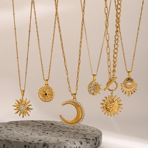 Golden stainless steel necklace set featuring star, moon, and compass charms with CZ stones