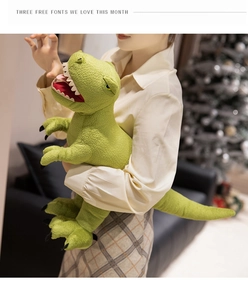 Close-up of green dinosaur plush toy showing textured fabric and soft filling in arms