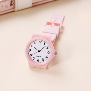 Detailed view of pink silicone strap and clean white quartz watch face with bold numbers