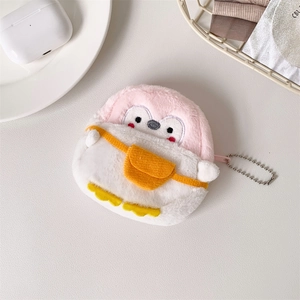 Close-up of pink and white plush penguin coin purse with silver chain on textured desk