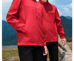 Detail of a red softshell hiking jacket featuring windproof zippers and elastic cuffs
